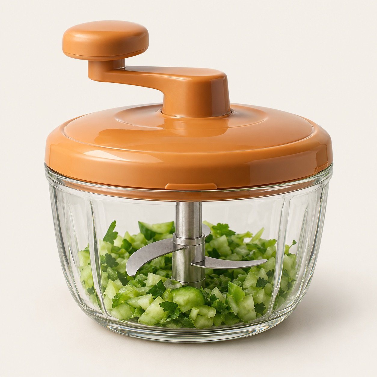 Manual kitchen chopper with a clear bowl and an orange lid